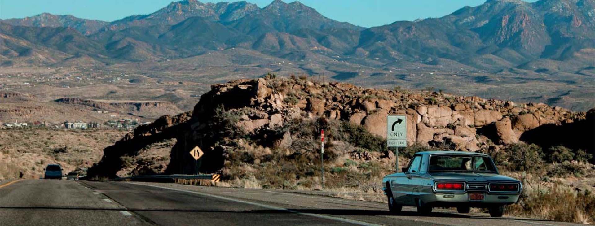 A vehicle traveling down an open road, representing reliable auto insurance and liability protection for Arizona drivers.